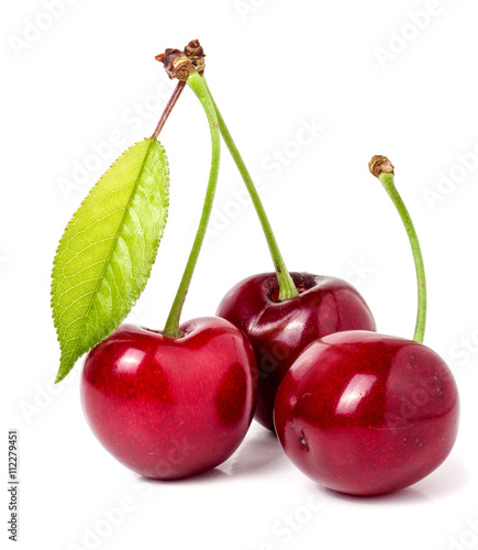 Three cherries with leaf closeup isolated on white background