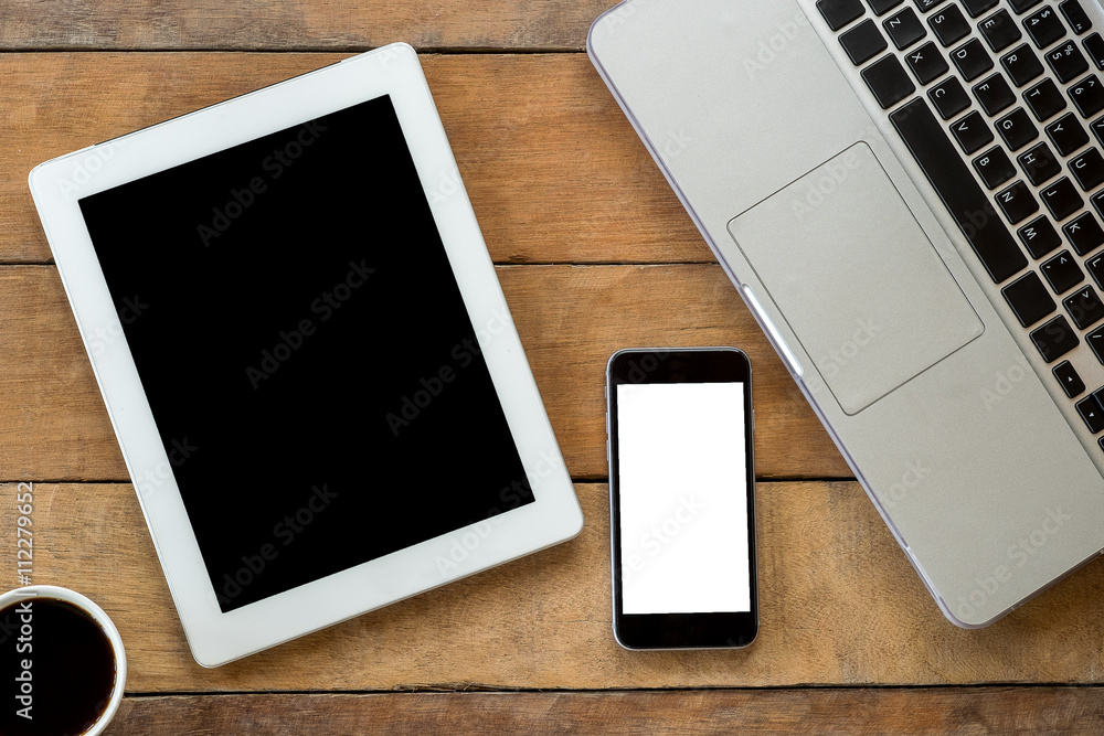 Office desk with blank screen smartphone, cup of coffee, tablet and labtop . Flat lay photo.Top view with copy space Office desk with blank screen smartphone, cup of coffee, tablet and labtop . Flat lay photo.Top view with copy space