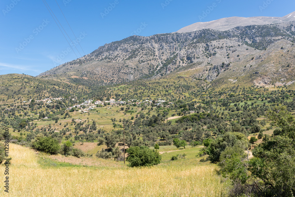 On the old road to Rethymnon in springtime. View to the mountain village Kouroutes on Crete. In the background, the Ida mountain range with the Psiloritis as the highest elevation on Crete 