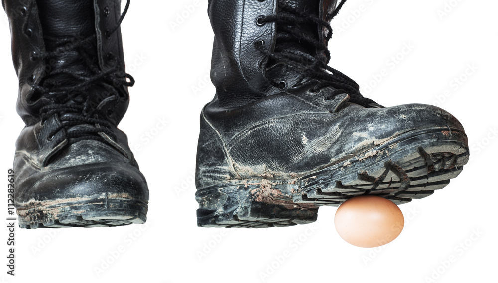 Old black army boots trampling egg. The egg as a symbol of the beginning,  emotional shot. Focus on the egg and the sole of the right shoe Photos |  Adobe Stock