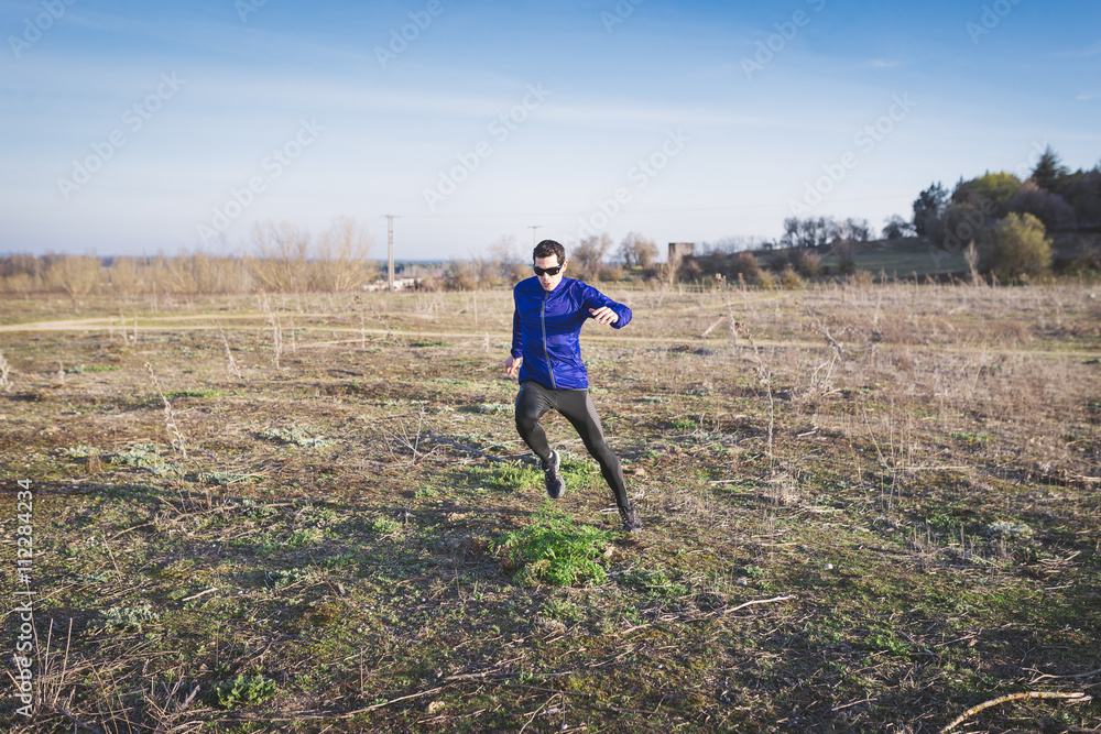 Man running in a promenade outdoors. Man is training Man running in a promenade outdoors. Man is training