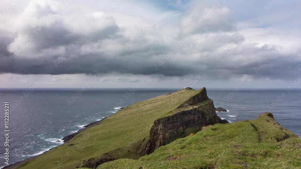 4K time lapse of a remote island with a lighthouse in the distance, filmed on Mykines, Faroe Islands 4K time lapse of a remote island with a lighthouse in the distance, filmed on Mykines, Faroe Islands