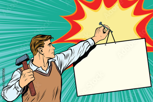 Worker nailing a poster to the wall