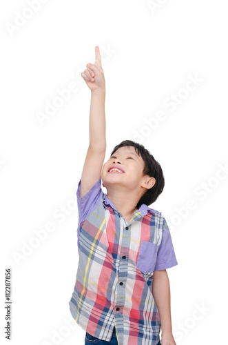 Young asian boy pointing up over white background