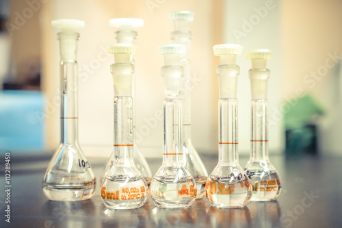 chemical bottles on table in laboratory