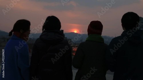 Men and women looking at each other and talking at sunset