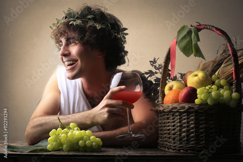 Laughing Bacchus holding a glass photo