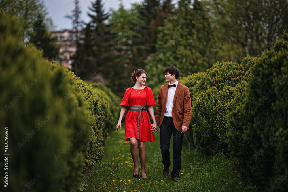 Happy and smiled couple walking in love at park garden. Stylish