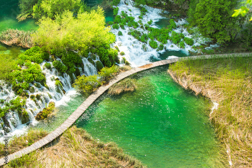     Beautiful landscape, waterfall, clear green water and wooden pathway in the Plitvice Lakes National Park in Croatia. Beautiful world. Panoramic view.  © ilijaa
