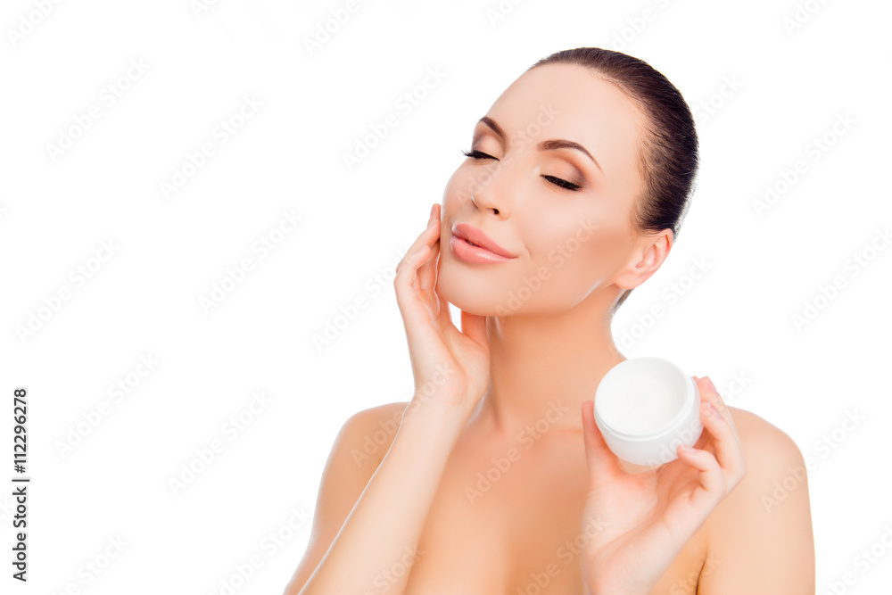 Sensual happy woman applying cream on her face Sensual happy woman applying cream on her face