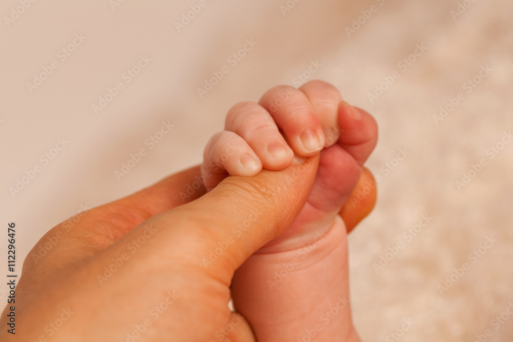 Father holding hand of a newborn baby. Horizontal shot Father holding hand of a newborn baby. Horizontal shot