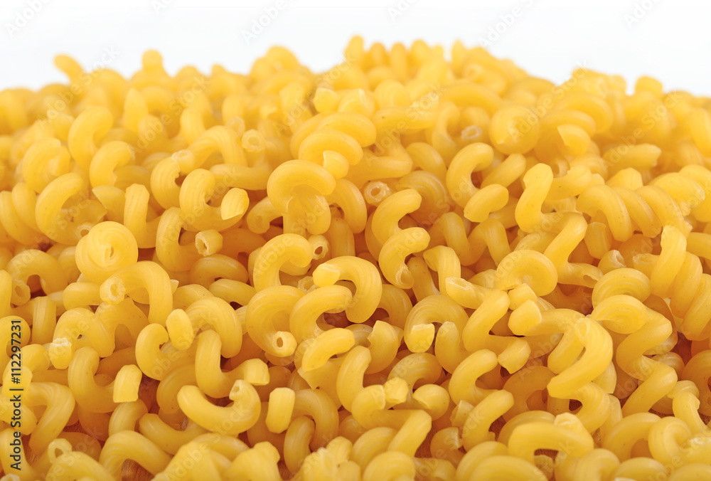 Heap of uncooked italian pasta on a white Heap of uncooked italian pasta on a white