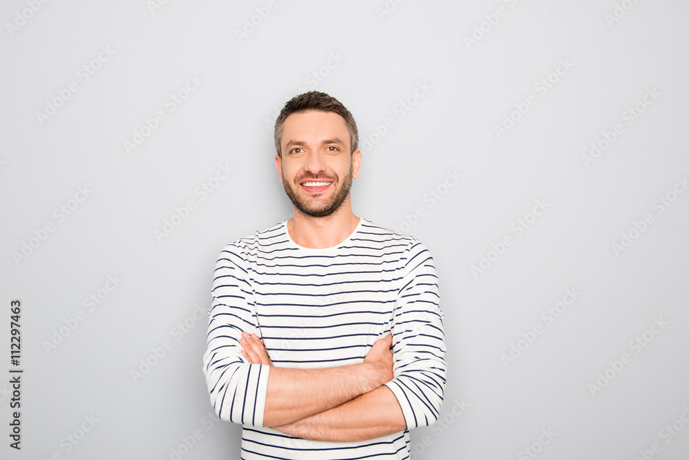Cheerful happy guy with crossed hands on white background Cheerful happy guy with crossed hands on white background