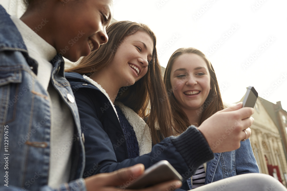Teenage Girls Using Mobile Phones In Urban Setting Teenage Girls Using Mobile Phones In Urban Setting