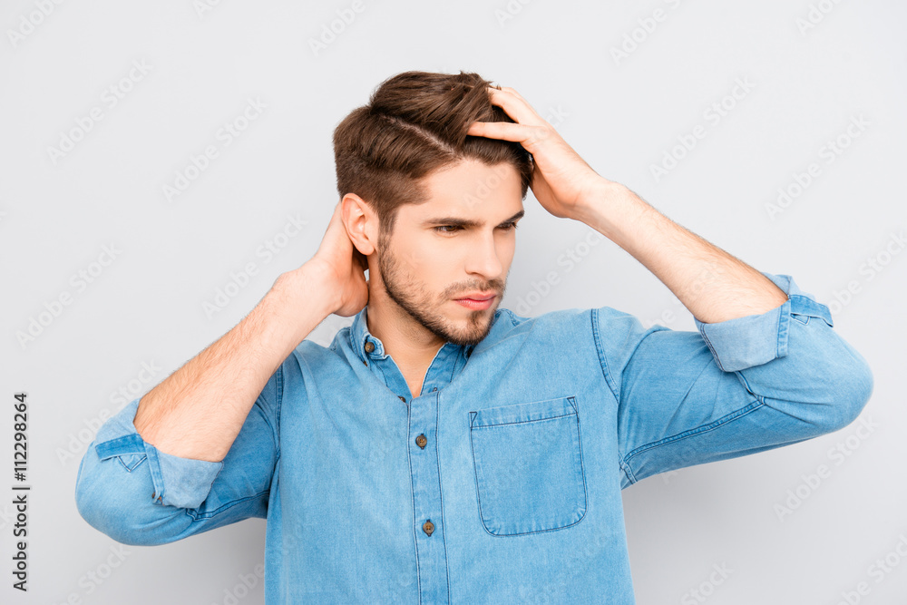 Portrait of healthy man combing his hair with fingers Portrait of healthy man combing his hair with fingers