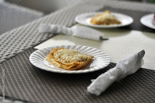 Morning omelet with cheese on the dinner table with fork and kni photo