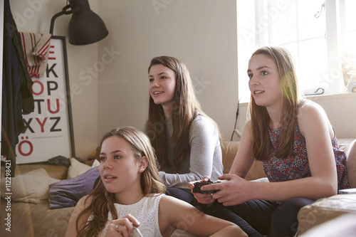 Teenage girls playing video game in bedroom