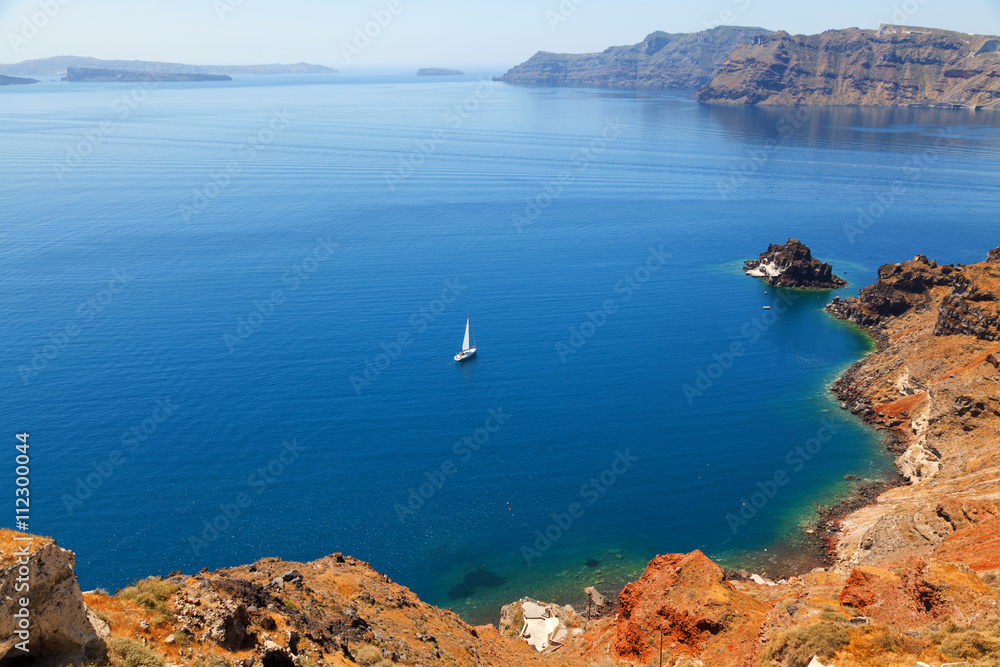 A perfect view of the volcano in Oia, Santorini with blue waters of the sea