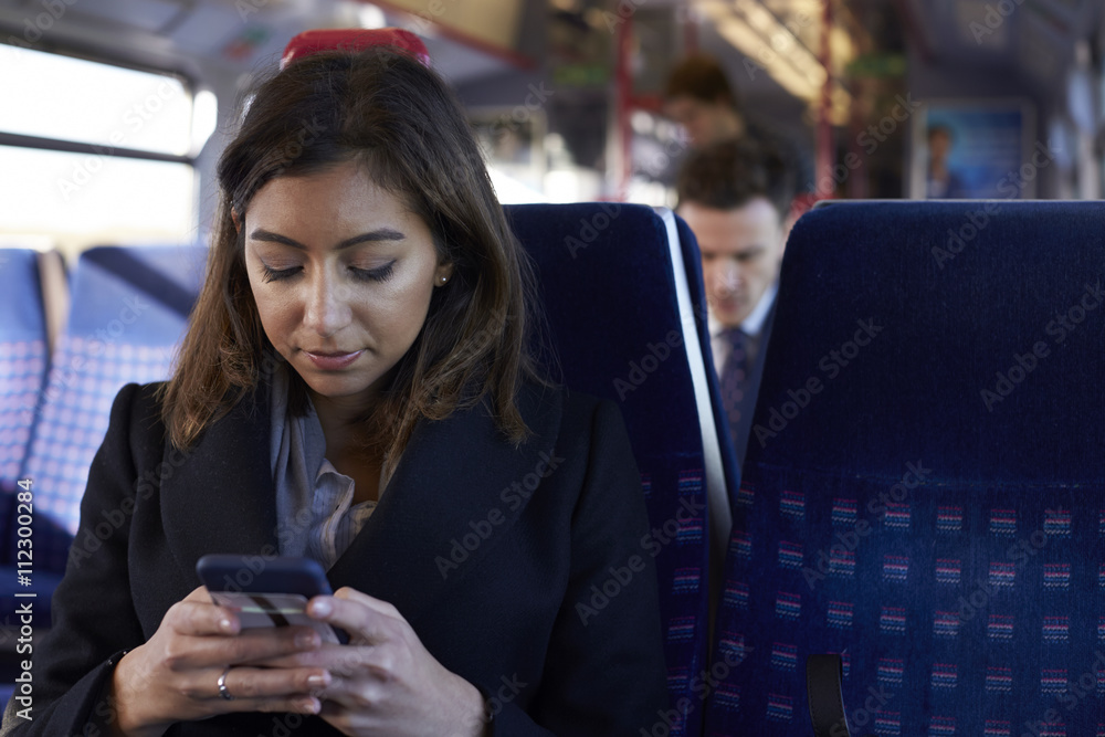 Businesswoman Reading Text Message On Train During Commute Businesswoman Reading Text Message On Train During Commute
