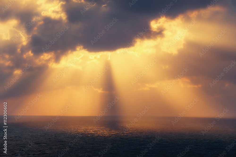 golden sun rays on the sea at sunset