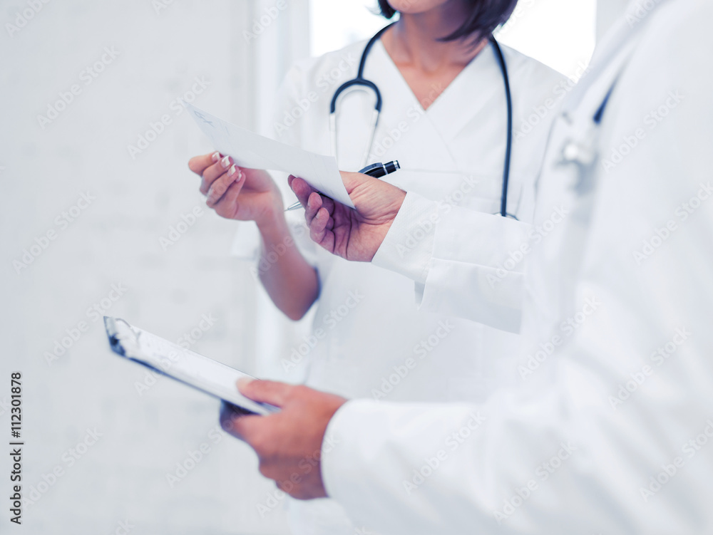 two doctors writing prescription two doctors writing prescription