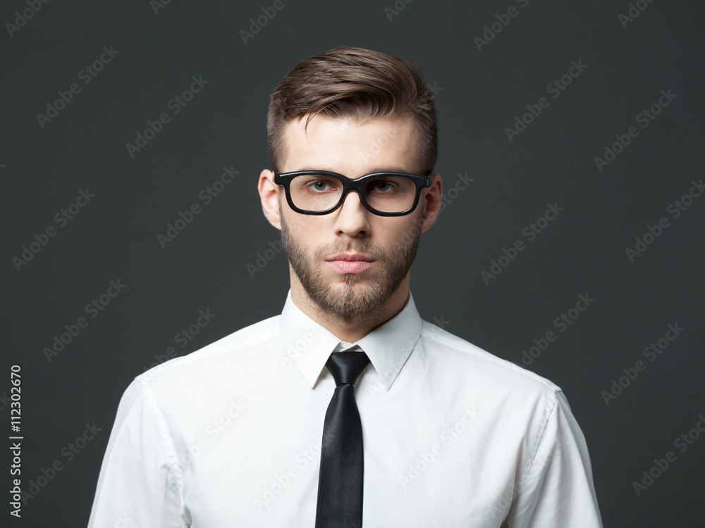 Portrait of handsome young businessman on dark background. Portrait of handsome young businessman on dark background.