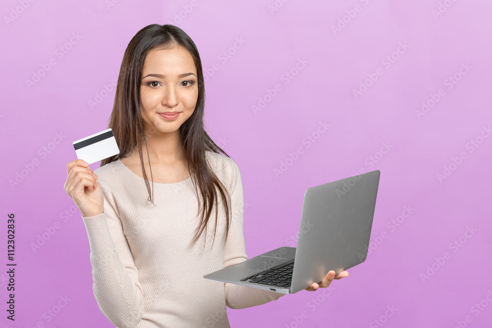 Woman shopping on computer with credit card Woman shopping on computer with credit card