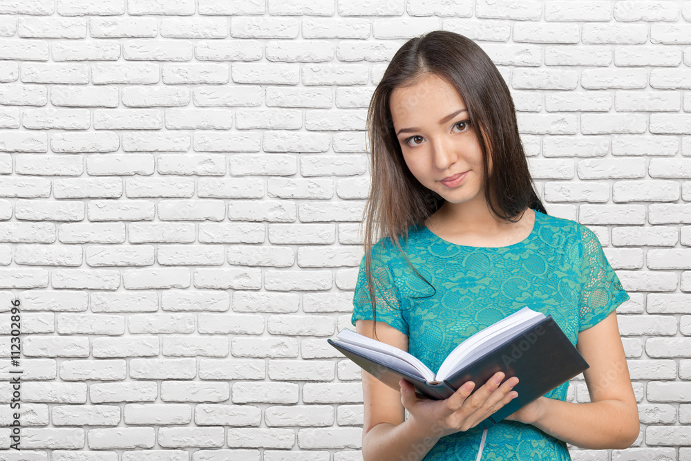 Woman university / college student holding book Woman university / college student holding book