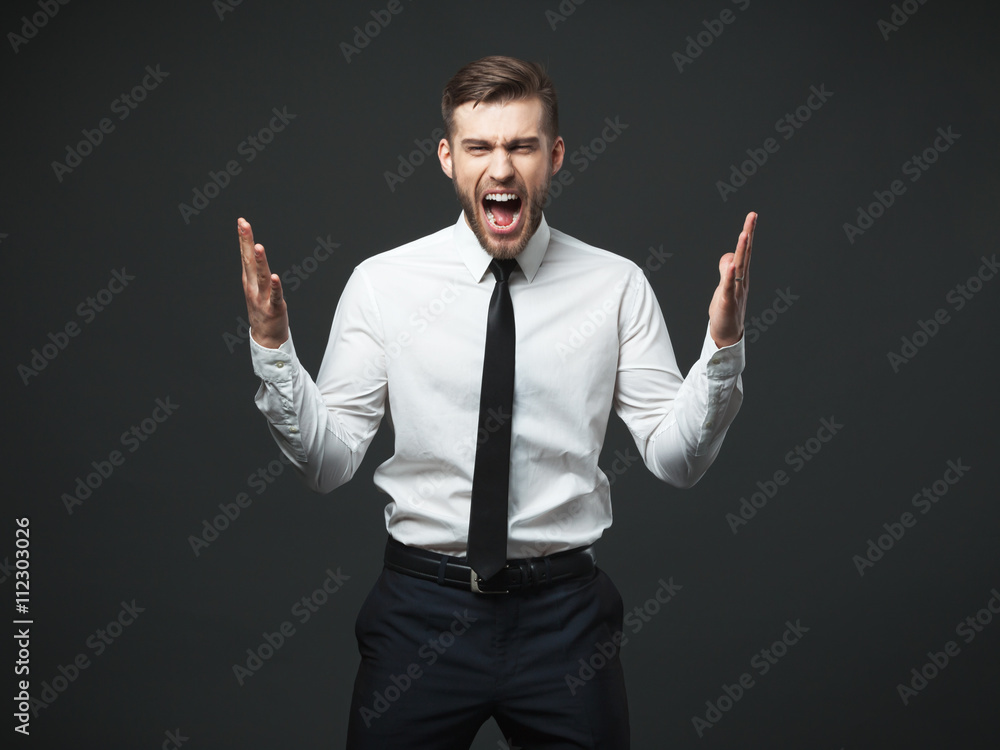 Young businessman screaming at camera isolated. Young businessman screaming at camera isolated.