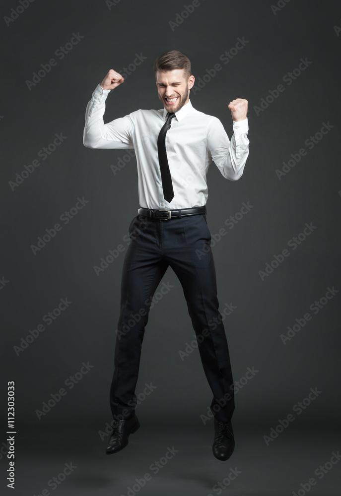 Handsome young businessman celebrating his success. Handsome young businessman celebrating his success.