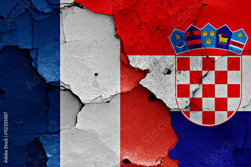flags of France and Croatia painted on cracked wall