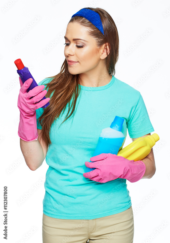 Smiling woman read instructions on the bottle with cleaner. Smiling woman read instructions on the bottle with cleaner.