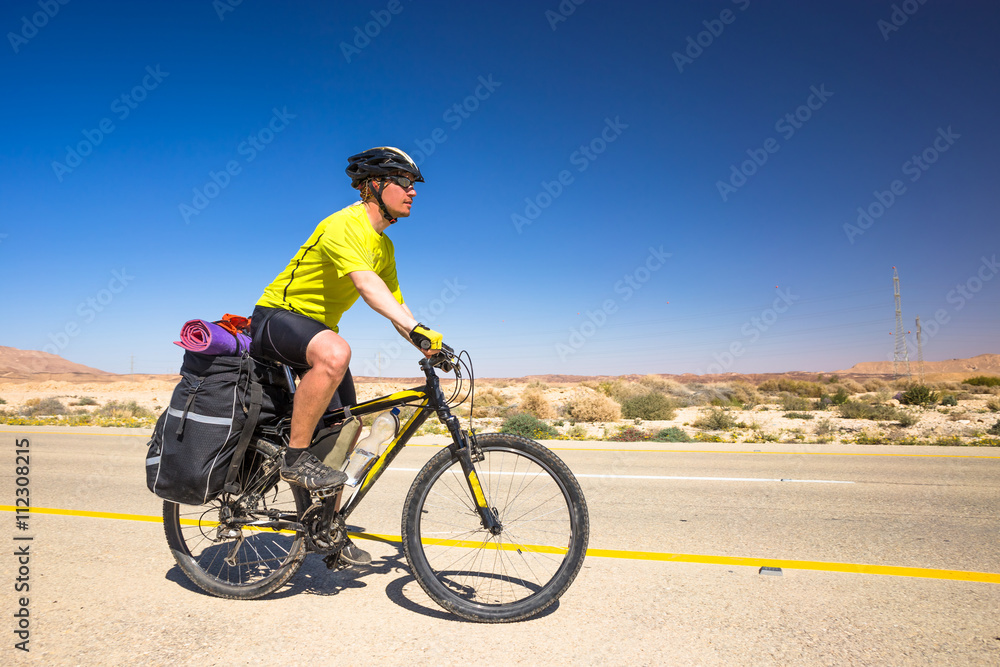 Fototapeta premium Happy biker relax on beautiful road in Israel desert. Sunny hot day