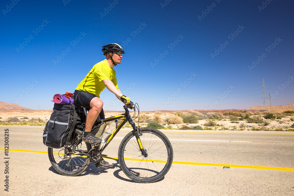 Happy biker relax on beautiful road in Israel desert. Sunny hot day