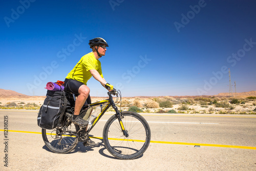Happy biker relax on beautiful road in Israel desert. Sunny hot day