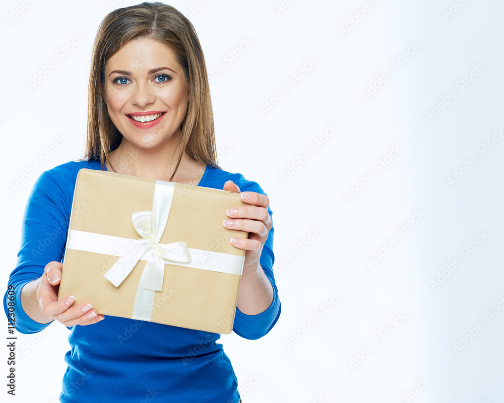 Casual dressed smiling woman holding gift box. Isolated. Casual dressed smiling woman holding gift box. Isolated.