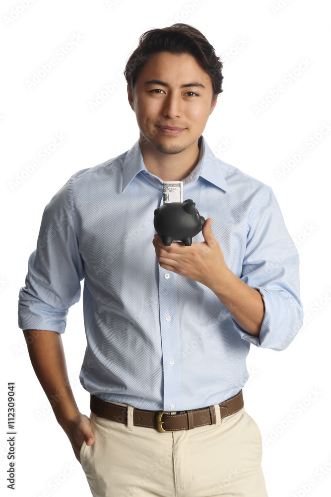 eigendom Museum natuurlijk An attractive man in a light blue shirt and khaki pants standing against a  white background smiling, holding a black piggy bank with a dollar bill  sticking out. Stock Photo | Adobe