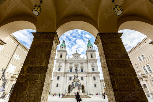 Wide-angle view of famous historic Salzburg Cathedral and Maria Immaculata column at Domplatz square in spring, Salzburg, Austria photo