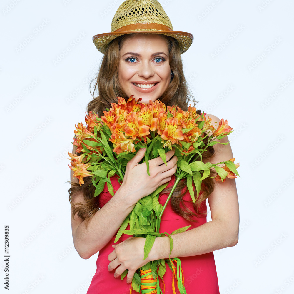 Toothy smiling young woman with bouquet  spring flowers.