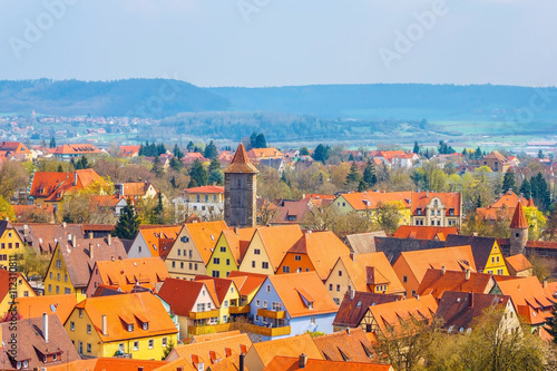 Traditional houses and buildings in old medieval town of Rothenburg ob der Tauber with orange roofs, Bavaria romantic road of Germany.
