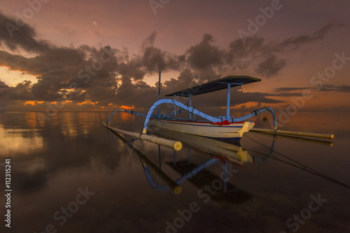 Beautiful Sunrise Scene in Bali, Indonesia. The 'Jukung' is widely use as fishing boat by the local fisherman