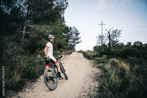 Mountain biker having a rest on a trail photo