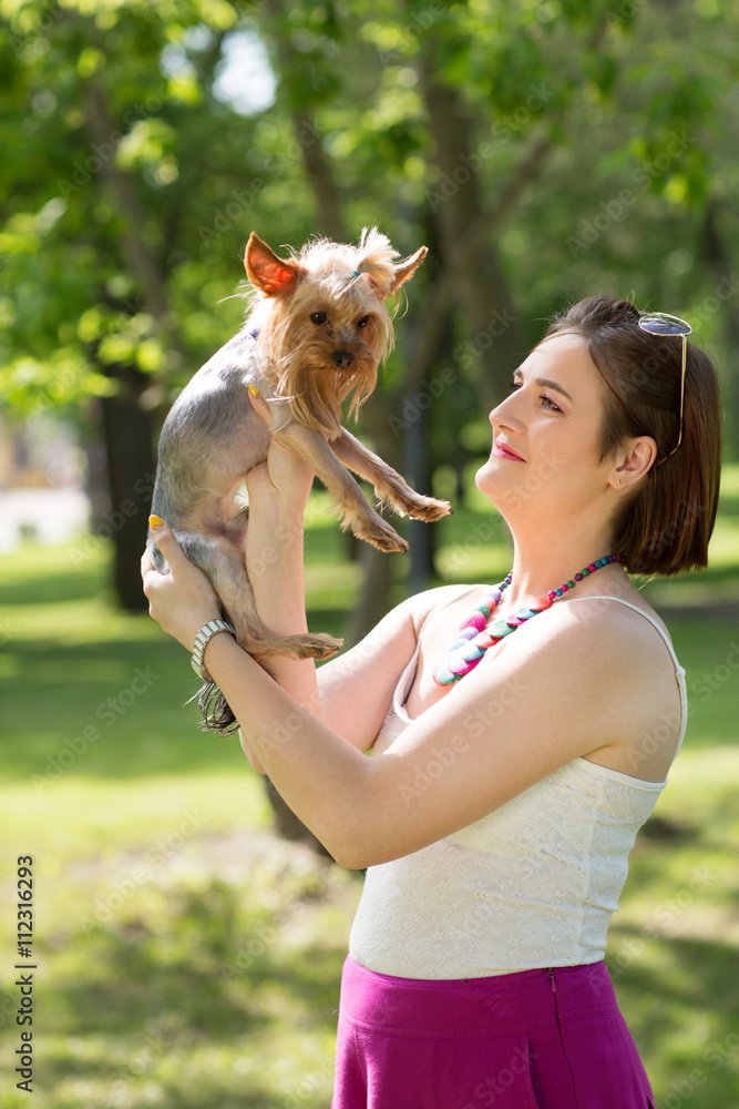 woman beautiful young happy holding small dog in summer day walks in park
woman beautiful young happy holding small dog in summer day walks in park