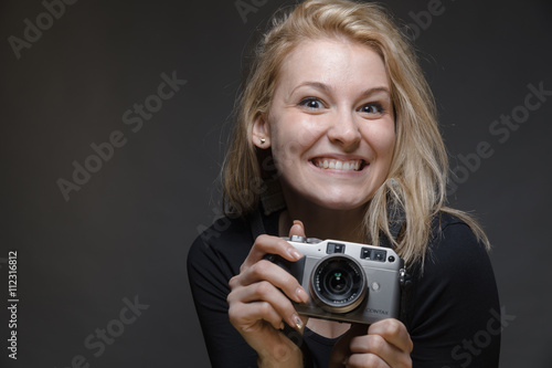 Happy smiling girl with vintage camera