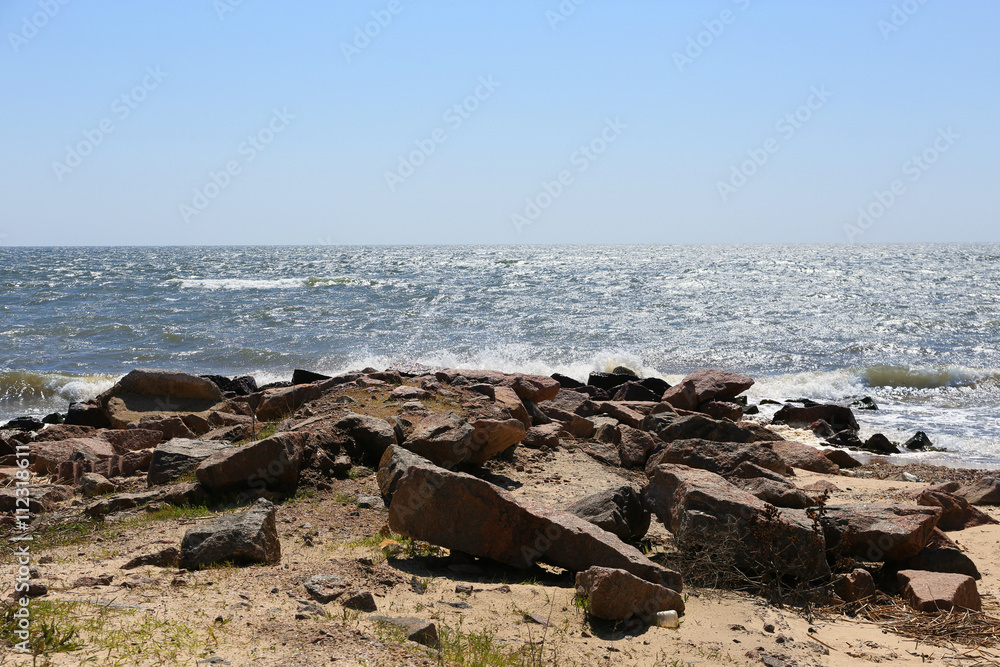 Rock seacoast with blue sea on background