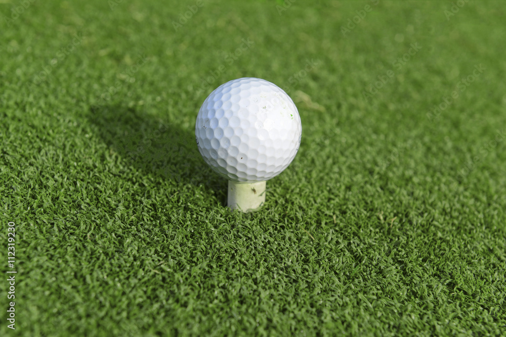 golfball on tee in teebox on golf course golfball on tee in teebox on golf course