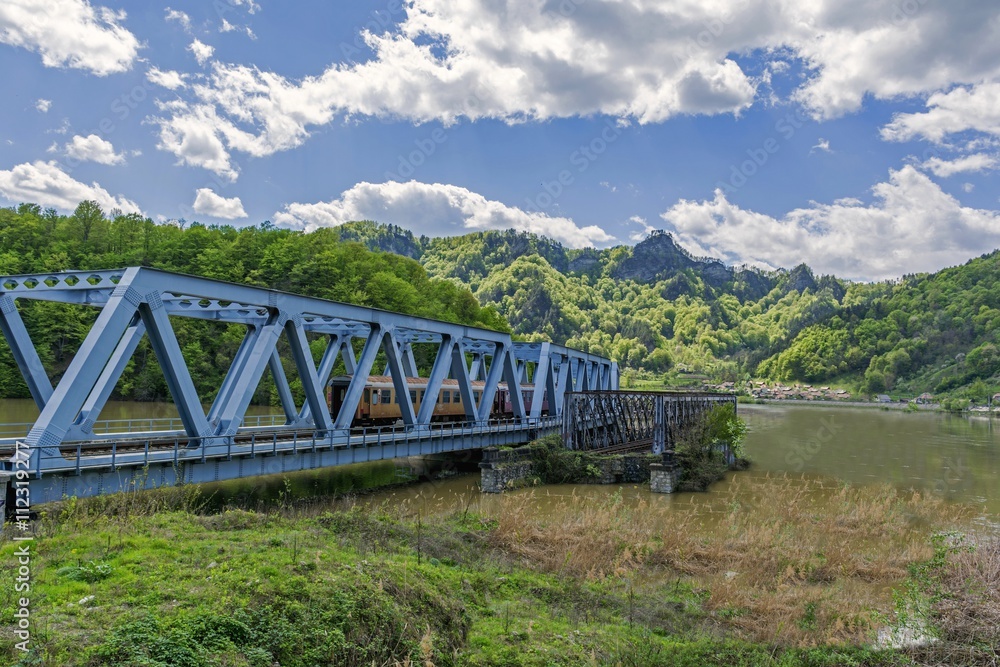 Passenger train crossing a bridge Passenger train crossing a bridge