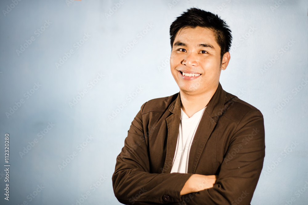 Smiling Asian businessman crossing his arms - business concept,b Smiling Asian businessman crossing his arms - business concept,b