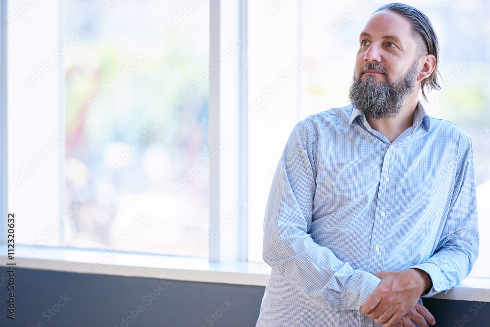 Fototapeta premium Mature man with silvering beard looking off camera