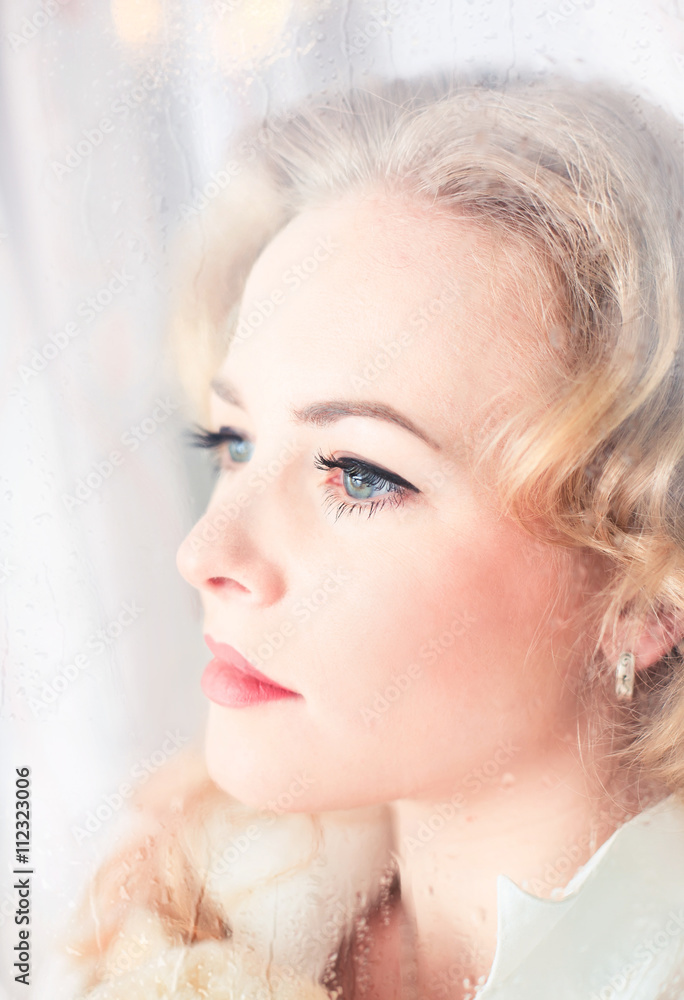 Portrait of a beautiful woman close-up window Portrait of a beautiful woman close-up window